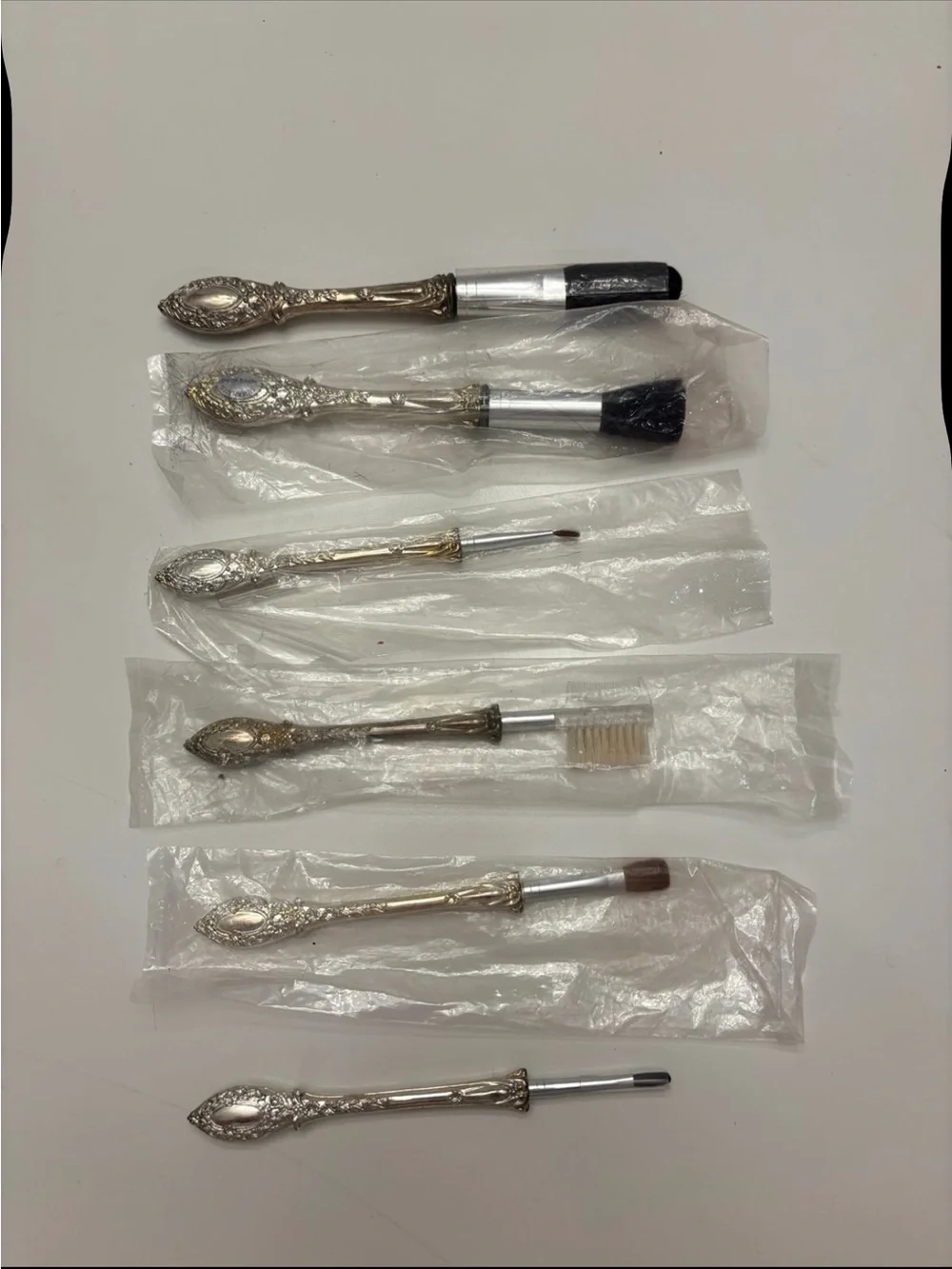 Vintage 6-piece silver-plated makeup brush vanity set with ornate scroll handle